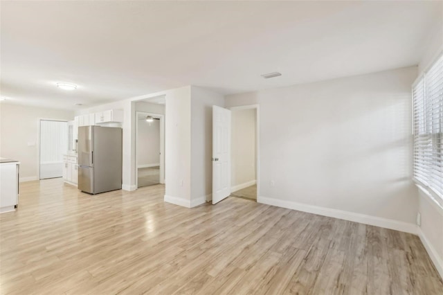 unfurnished room with light hardwood / wood-style floors