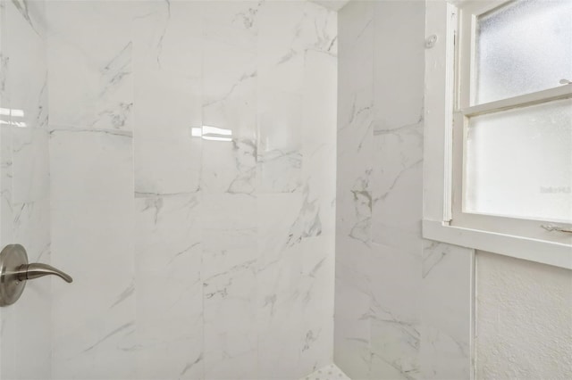 bathroom with tiled shower