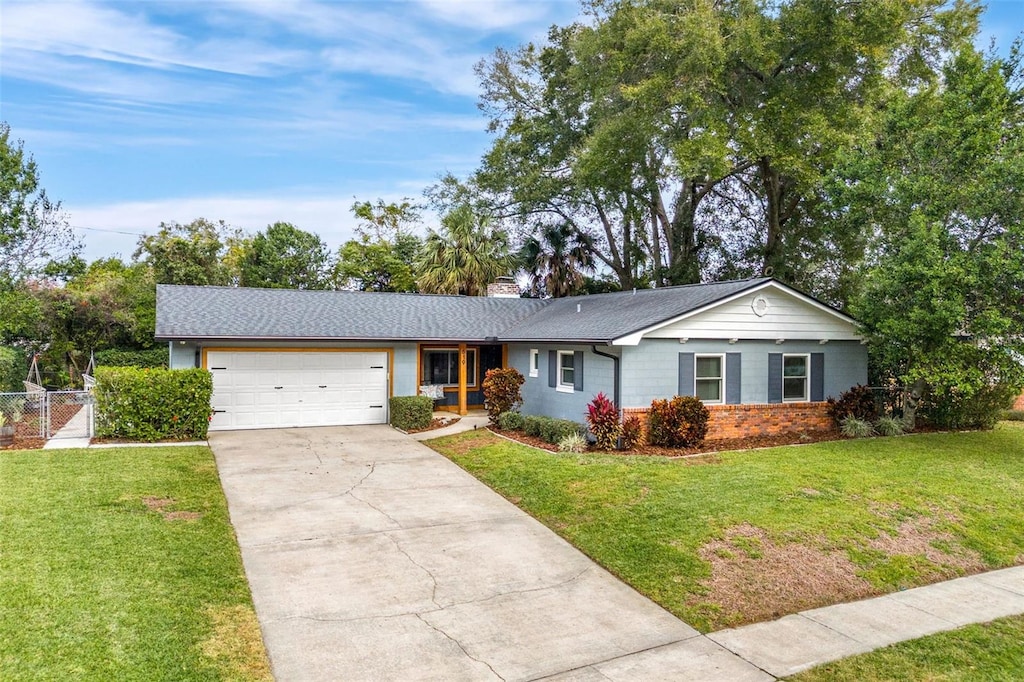 single story home with a front yard and a garage