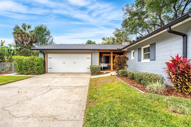 single story home featuring a front lawn and a garage