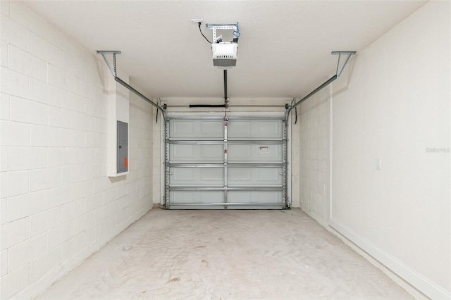 garage with a garage door opener and electric panel