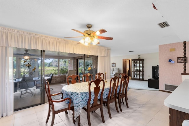 tiled dining room with ceiling fan