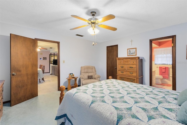 bedroom with connected bathroom, ceiling fan, and a textured ceiling