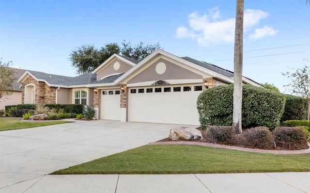 ranch-style house featuring a front lawn and a garage