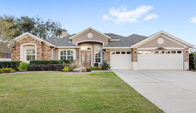 ranch-style home featuring french doors, a front yard, and a garage