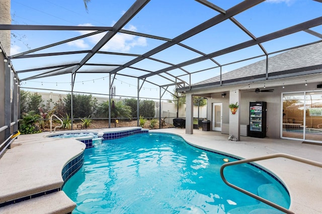 view of swimming pool with ceiling fan, a lanai, a patio, and an in ground hot tub