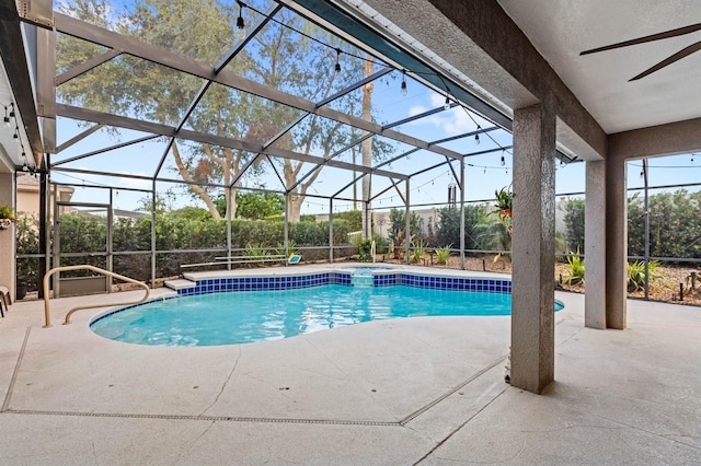 view of swimming pool featuring ceiling fan, a lanai, and a patio