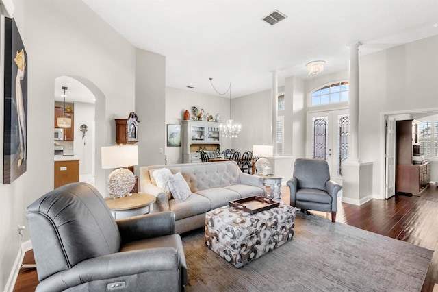 living room featuring french doors, dark hardwood / wood-style flooring, and a high ceiling