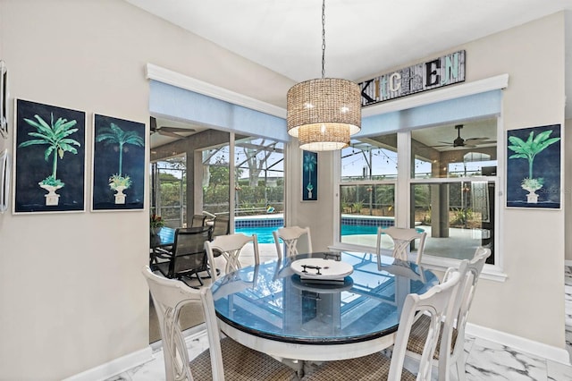 dining space featuring ceiling fan with notable chandelier