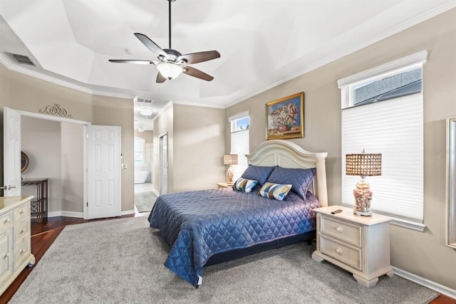 bedroom featuring a tray ceiling, ceiling fan, crown molding, and dark wood-type flooring