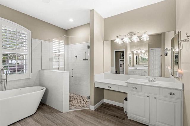 bathroom featuring vanity, wood-type flooring, and independent shower and bath