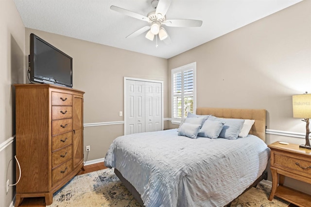 bedroom with light hardwood / wood-style floors, a closet, and ceiling fan