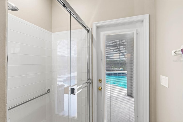 bathroom featuring a shower with shower door