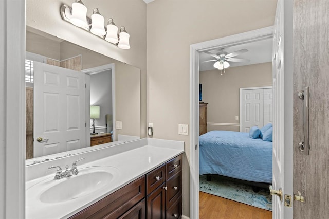 bathroom featuring hardwood / wood-style floors, vanity, and ceiling fan