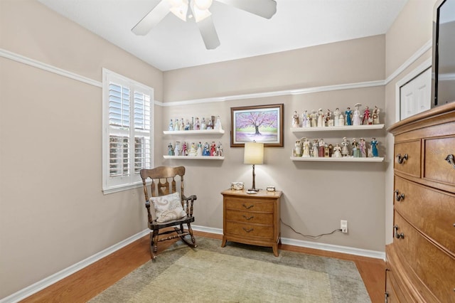 living area featuring bar area, light hardwood / wood-style flooring, and ceiling fan