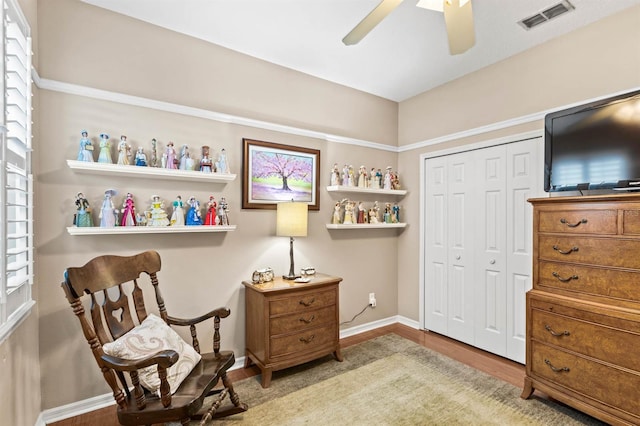 sitting room with ceiling fan and light hardwood / wood-style floors