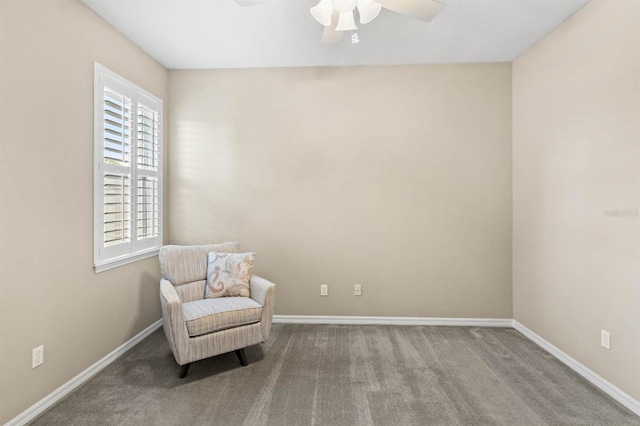 living area with carpet and ceiling fan