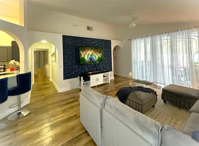 living room with light hardwood / wood-style flooring and lofted ceiling