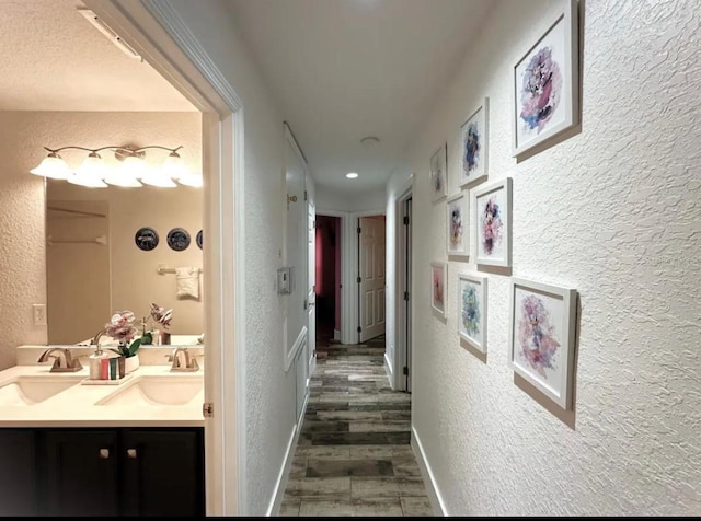 hall featuring sink and dark hardwood / wood-style floors