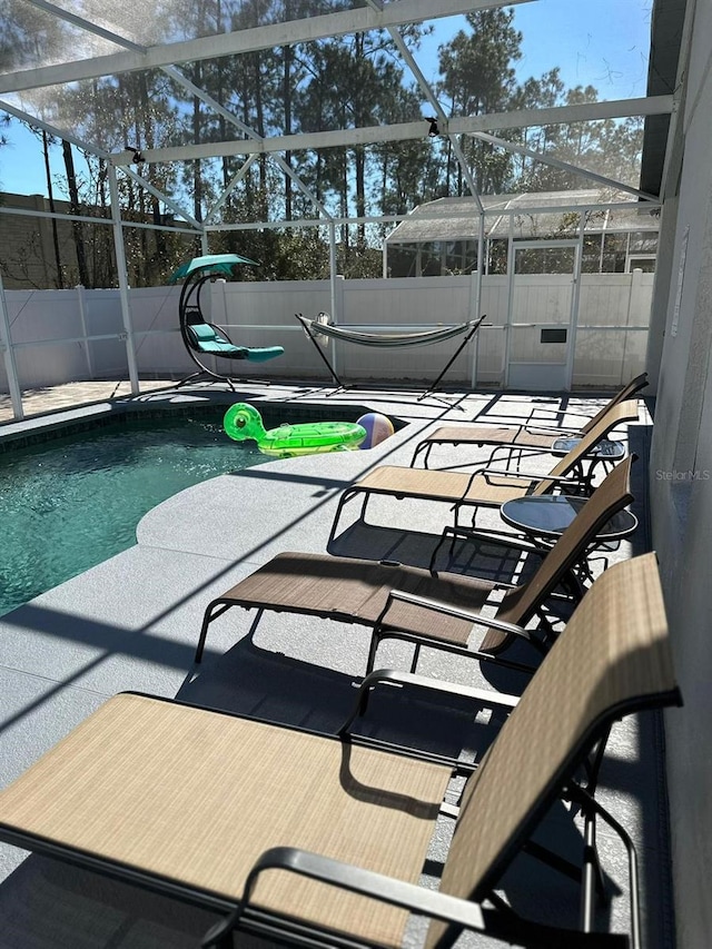 view of pool with a lanai and a patio