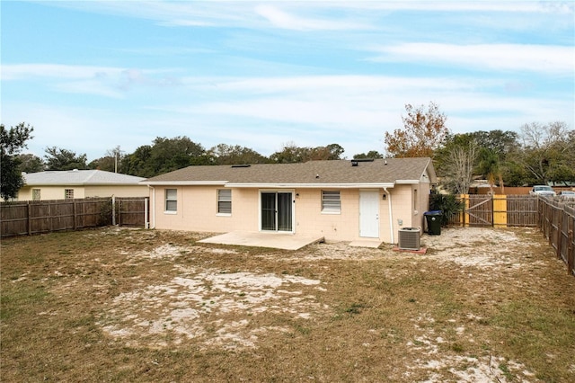 back of property with a patio area, cooling unit, and a lawn