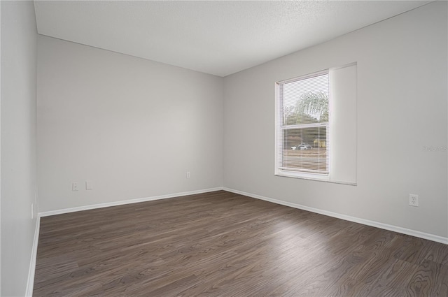 spare room featuring dark hardwood / wood-style flooring