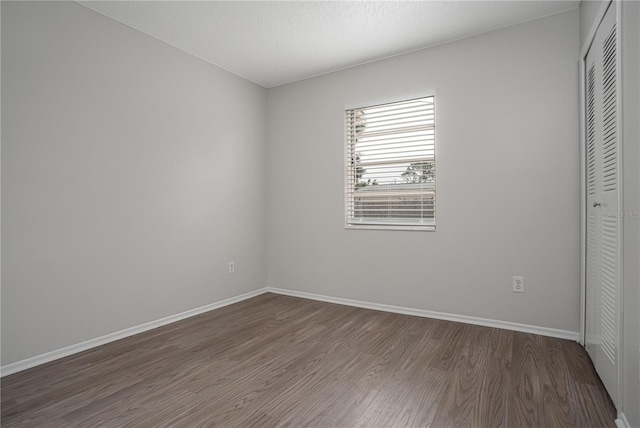 unfurnished room featuring dark hardwood / wood-style floors