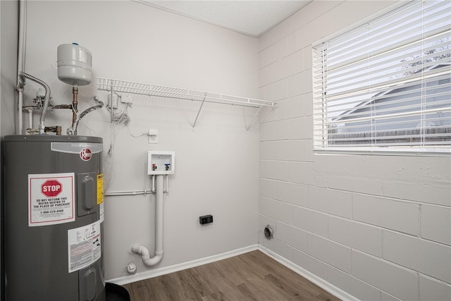 washroom featuring water heater, dark hardwood / wood-style floors, hookup for an electric dryer, and hookup for a washing machine