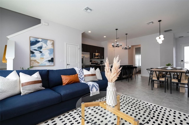 living room featuring a healthy amount of sunlight, light tile patterned flooring, and an inviting chandelier