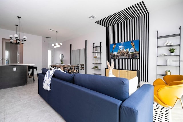 living room featuring light tile patterned floors and an inviting chandelier