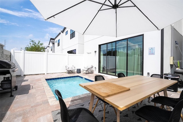 view of swimming pool featuring a patio and area for grilling