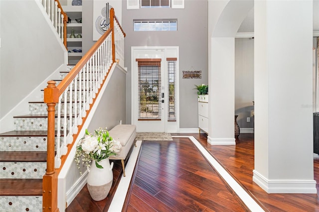 entrance foyer with a high ceiling and hardwood / wood-style flooring