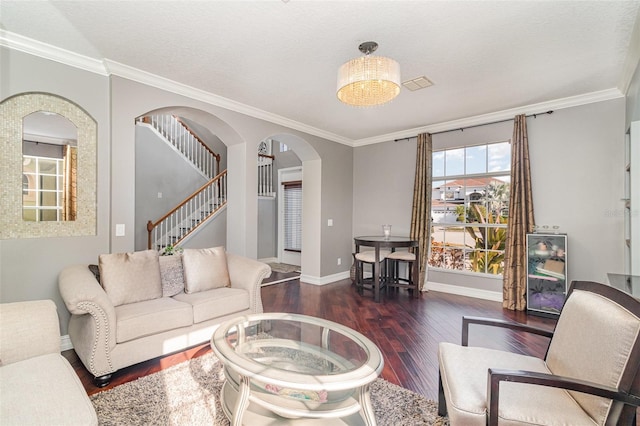 living room featuring a textured ceiling, dark hardwood / wood-style floors, and crown molding