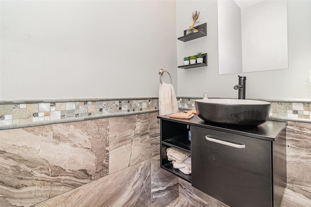 bathroom featuring vanity and tile walls