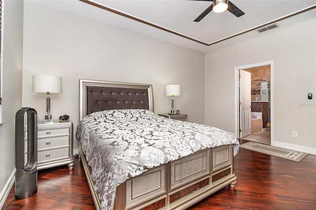 bedroom featuring a textured ceiling, connected bathroom, ceiling fan, and dark hardwood / wood-style floors