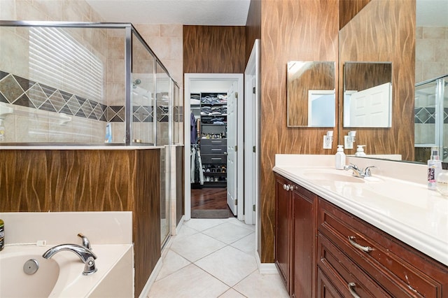 bathroom featuring tile patterned floors, separate shower and tub, and vanity