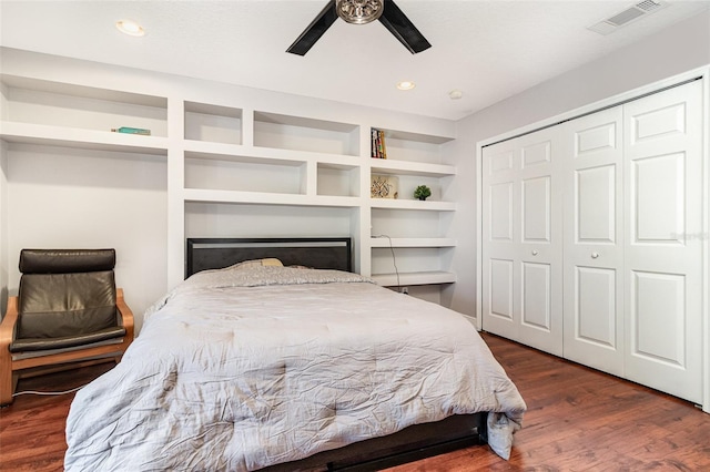 bedroom featuring dark hardwood / wood-style flooring, a closet, and ceiling fan