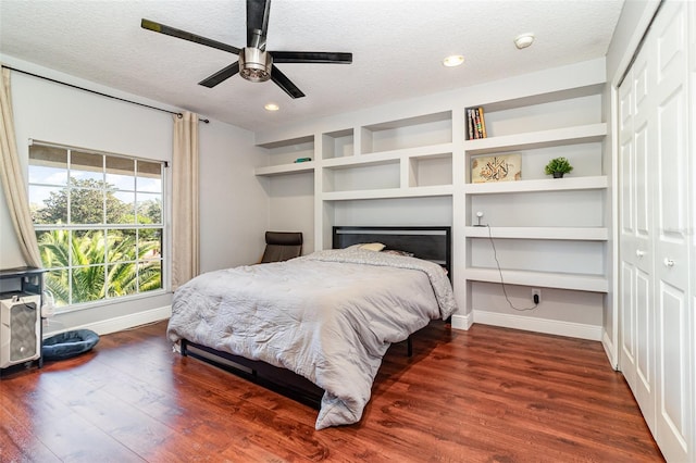 bedroom with ceiling fan, a closet, and hardwood / wood-style floors