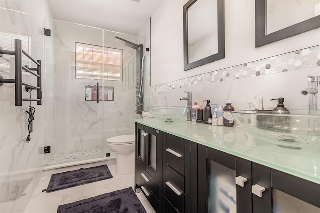 bathroom with walk in shower, vanity, tile walls, and toilet