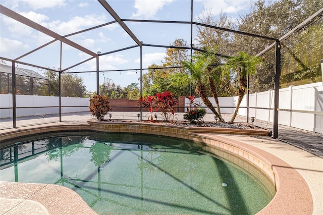 view of swimming pool with a patio and glass enclosure