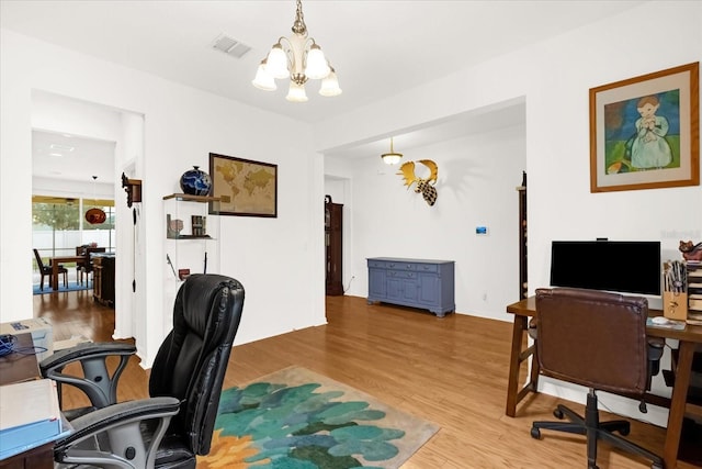 office area with a chandelier and light hardwood / wood-style floors