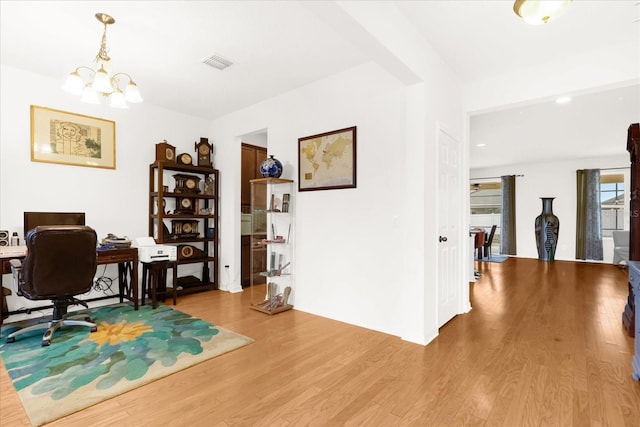 office area featuring hardwood / wood-style floors and a notable chandelier