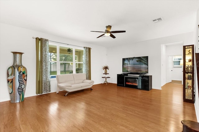 unfurnished living room featuring wood-type flooring and ceiling fan