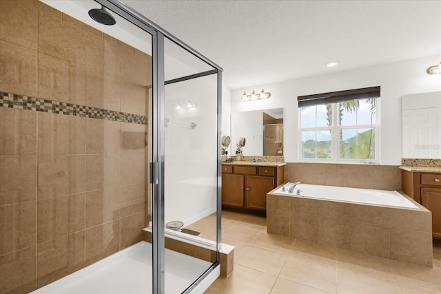 bathroom with tile patterned flooring, vanity, and separate shower and tub