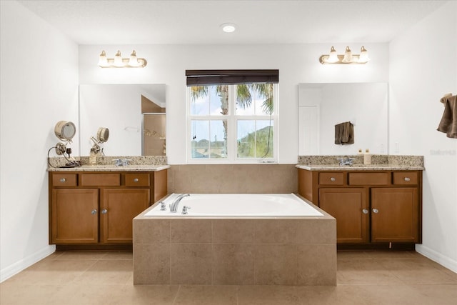 bathroom with tile patterned floors, vanity, and separate shower and tub