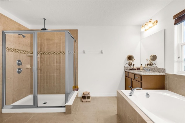 bathroom featuring tile patterned flooring, vanity, and separate shower and tub