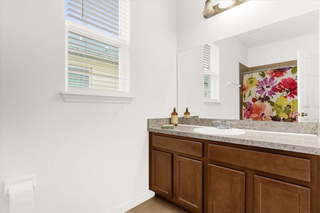 bathroom featuring a shower with shower curtain and vanity