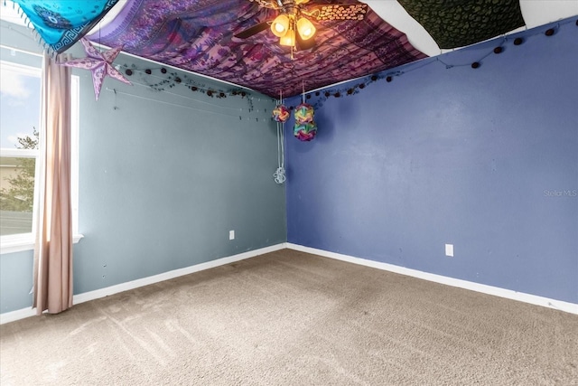 unfurnished room with ceiling fan and carpet floors