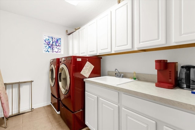 washroom featuring washer and dryer, light tile patterned floors, cabinets, and sink