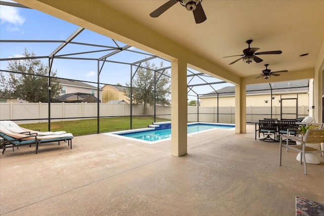 view of swimming pool featuring a lanai, a yard, and a patio